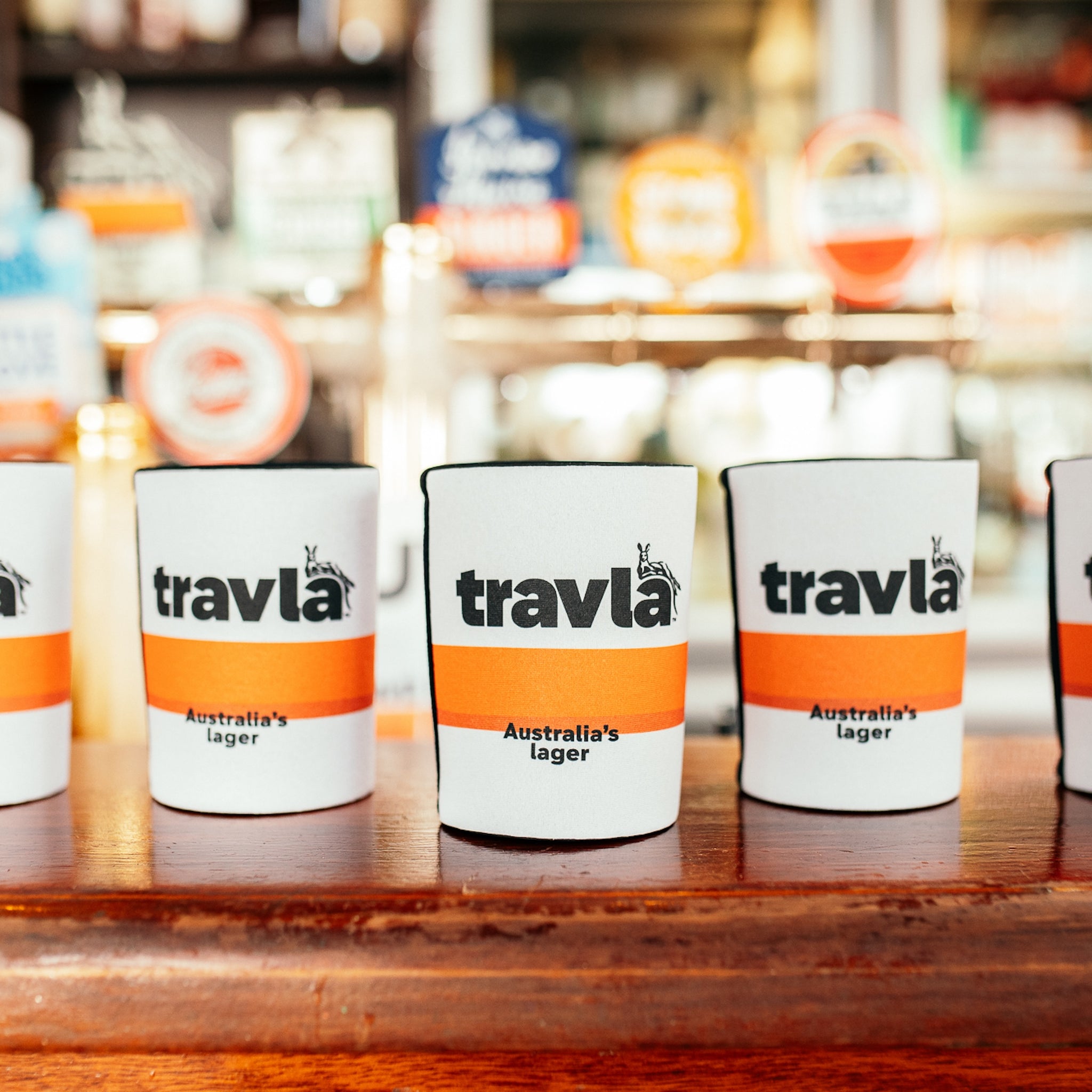 travla stubby holders lined up on a bar